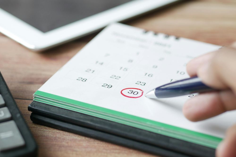 Man sitting beside woman looking at a contract on DocuSign